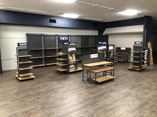 A store interior featuring multiple shelves stocked with a variety of products for sale.
